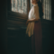 hypervigilant woman looking out window