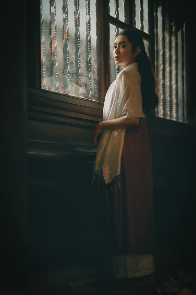 hypervigilant woman looking out window