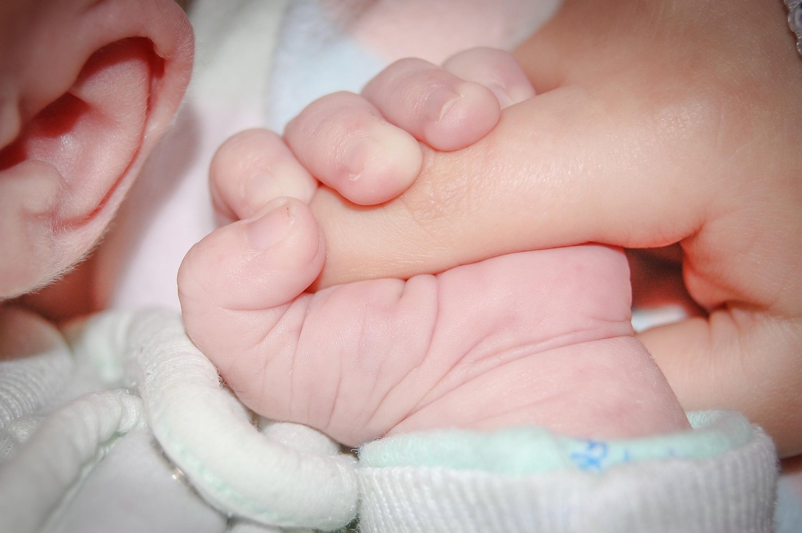 Baby holding a mothers finger