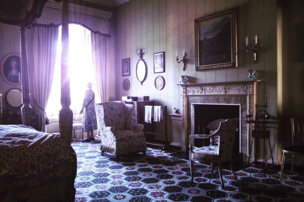 curtains sunlight depressed looking person standing in an old room